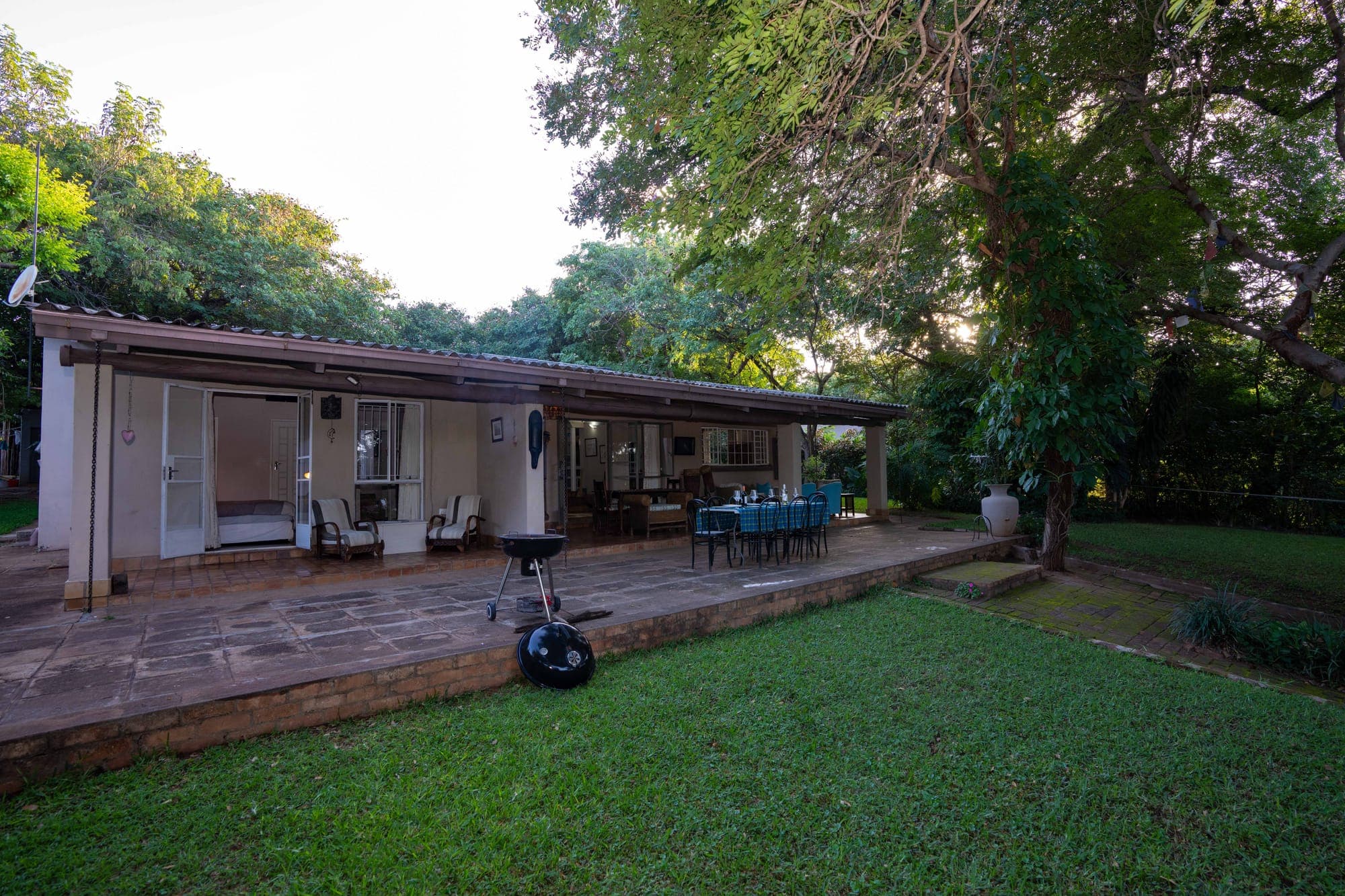 The Art House veranda and rolling lawn, Victoria Falls