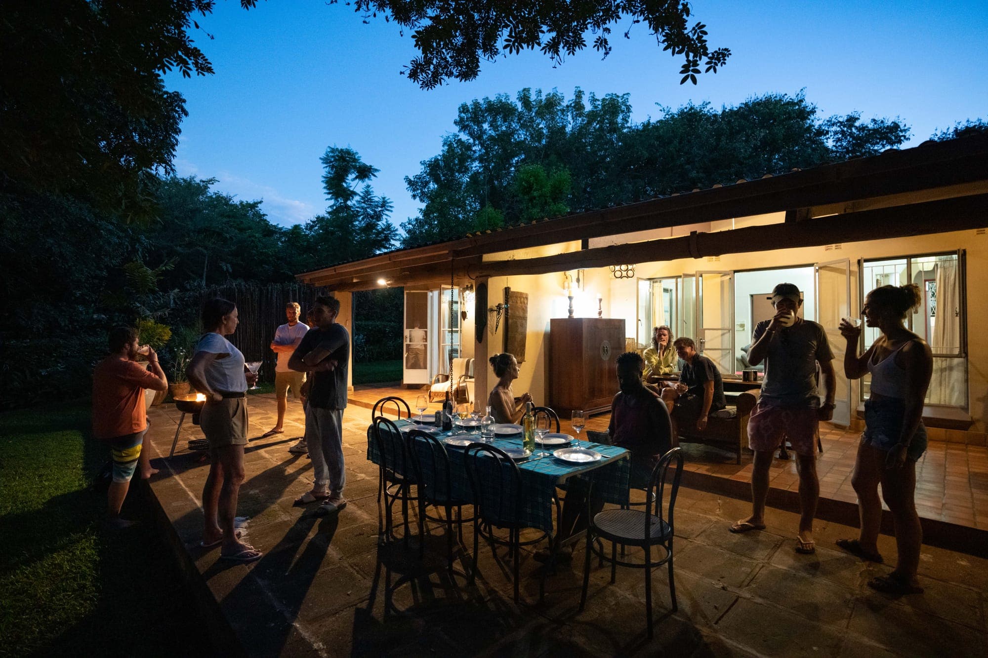 Guests gathering for dinner on the veranda at dusk, The Art House