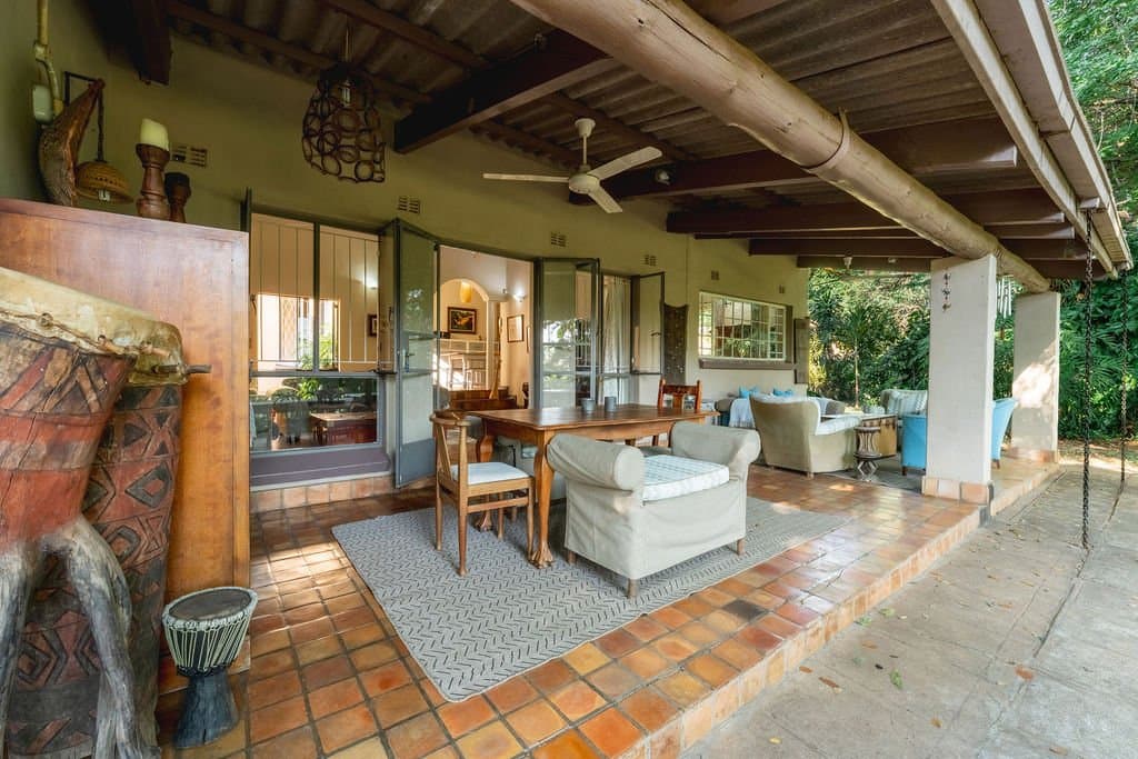 Veranda lounge with ceiling fans at The Art House