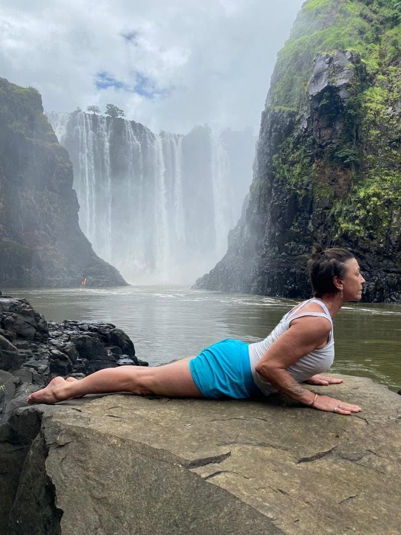 Sara practising yoga on the rocks below the Victoria Falls